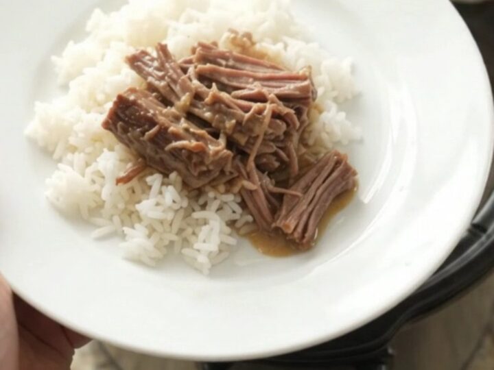 Shredded beef chuck roast with creamy Dijon gravy in a slow cooker