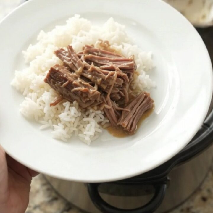 Shredded beef chuck roast with creamy Dijon gravy in a slow cooker