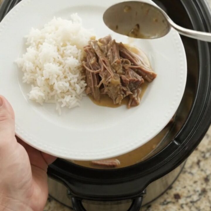 Slow cooker chuck roast with potatoes and carrots in creamy Dijon gravy