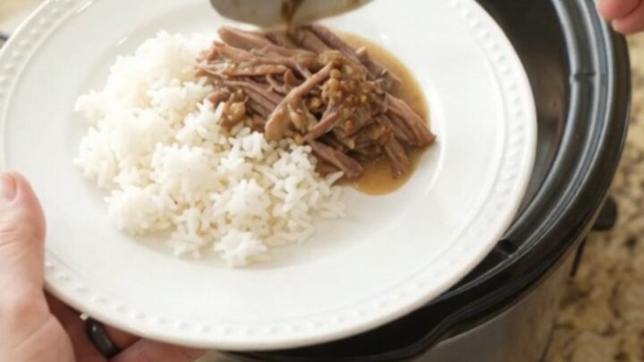 Shredded beef chuck roast in creamy Dijon sauce with portobello mushrooms in a slow cooker