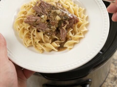 Slow-cooked beef brisket with mushrooms in a rich butter gravy, served over egg noodles