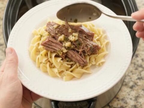 Fork-tender shredded beef brisket with pepperoncini and rich gravy in a slow cooker