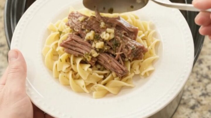 Fork-tender shredded beef brisket with pepperoncini and rich gravy in a slow cooker