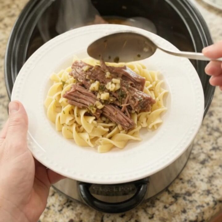 Fork-tender shredded beef brisket with pepperoncini and rich gravy in a slow cooker