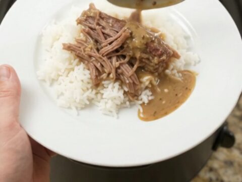 Fork-shredded beef brisket with pepperoncini and creamy gravy in a slow cooker