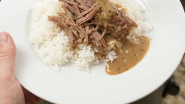 Fork-shredded beef brisket with pepperoncini and creamy gravy in a slow cooker