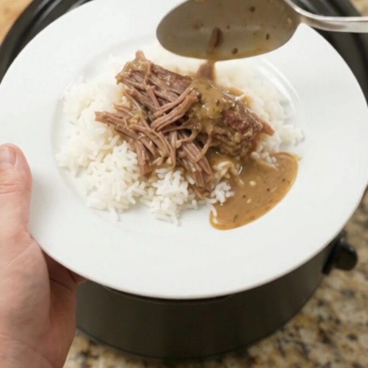 Fork-shredded beef brisket with pepperoncini and creamy gravy in a slow cooker