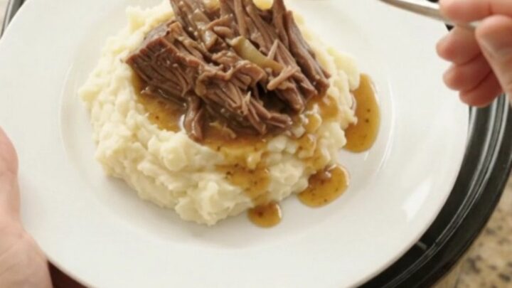 Shredded beef brisket with mushrooms and butter jus in a slow cooker