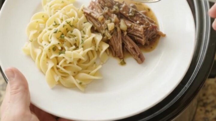 Fork-tender shredded beef brisket in rich garlic-herb gravy in a slow cooker