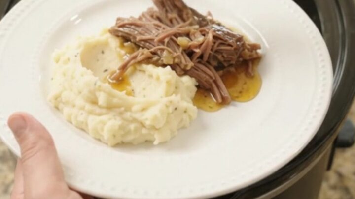 Shredded beef brisket with mushrooms and butter jus in a slow cooker