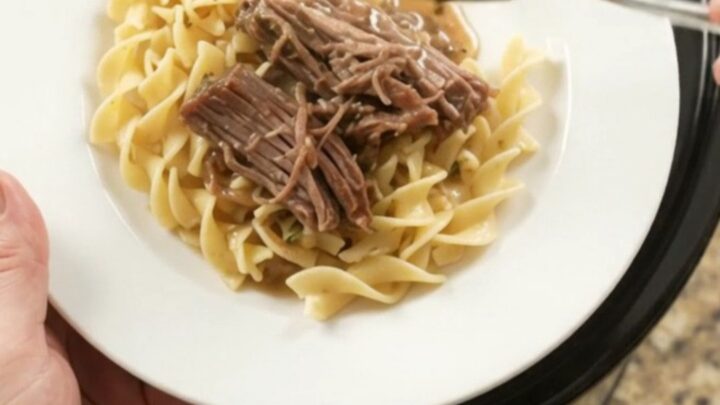 Shredded beef brisket with peppers and onions in a slow cooker