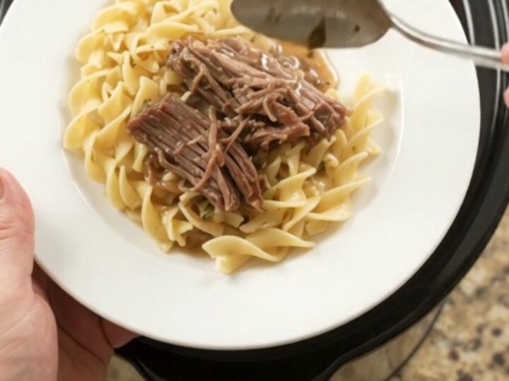 Shredded beef brisket with peppers and onions in a slow cooker