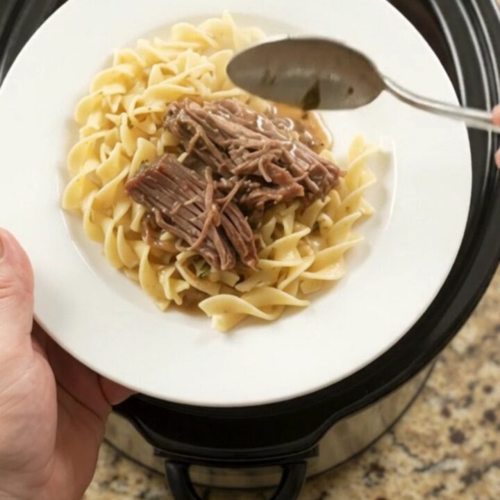 Shredded beef brisket with peppers and onions in a slow cooker