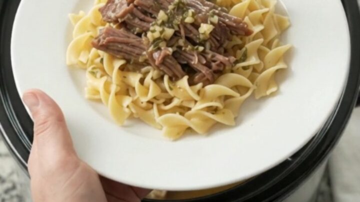 Slow-cooker beef brisket with portobello mushrooms and garlic butter gravy in a black crockpot