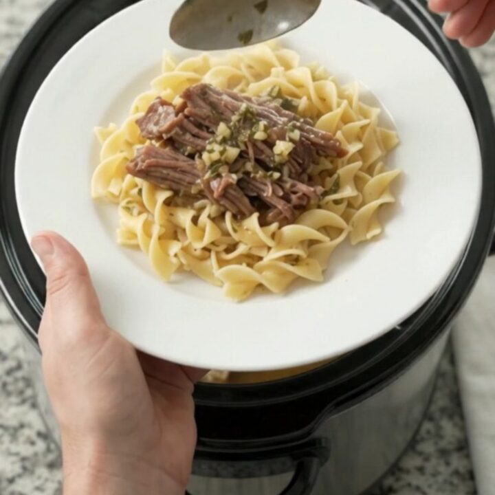 Slow-cooker beef brisket with portobello mushrooms and garlic butter gravy in a black crockpot