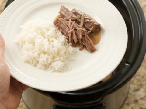 Fork-tender shredded beef brisket in creamy Dijon sauce with portobello mushrooms, served in a slow cooker