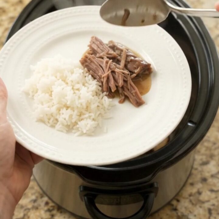 Fork-tender shredded beef brisket in creamy Dijon sauce with portobello mushrooms, served in a slow cooker