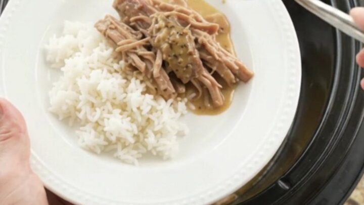 Slow-cooker pork shoulder with pepperoncini and creamy gravy in a black pot
