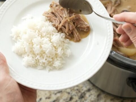 Shredded pork shoulder with mushrooms in creamy Dijon sauce in a slow cooker