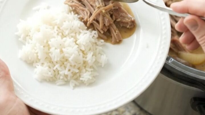 Shredded pork shoulder with mushrooms in creamy Dijon sauce in a slow cooker