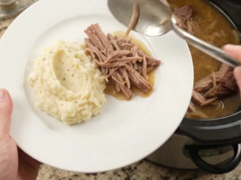 Slow cooker French onion butter pork shoulder with caramelized onions and buttery jus