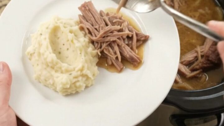 Slow cooker French onion butter pork shoulder with caramelized onions and buttery jus