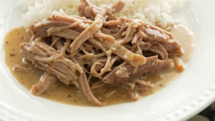 Slow-cooker pork shoulder with shallots and carrots in a creamy Dijon sauce, served over rice.