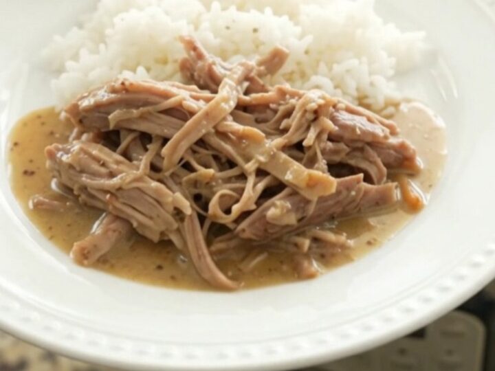 Slow-cooker pork shoulder with shallots and carrots in a creamy Dijon sauce, served over rice.
