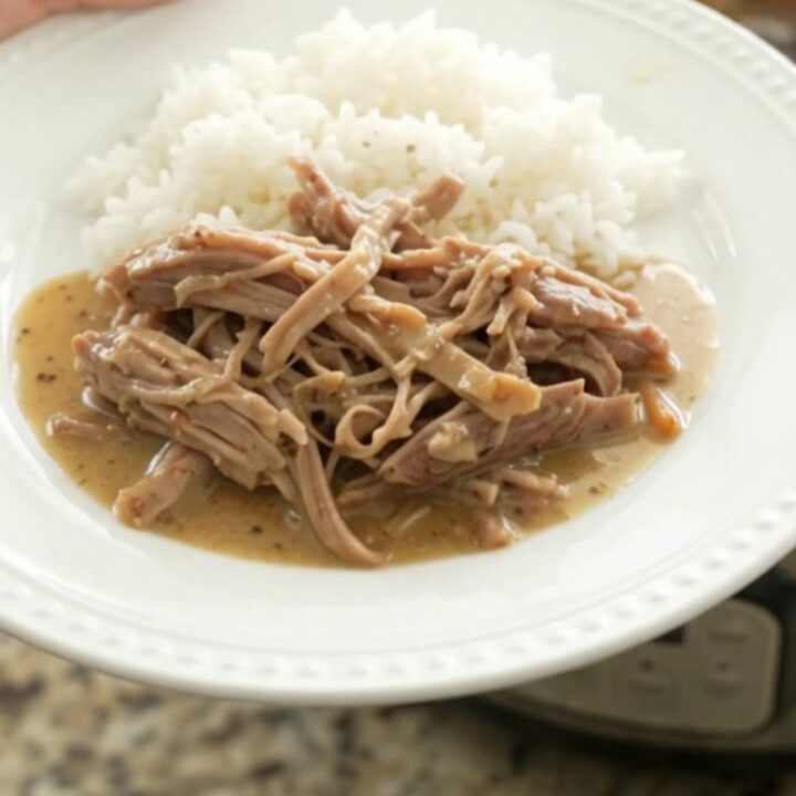 Slow-cooker pork shoulder with shallots and carrots in a creamy Dijon sauce, served over rice.