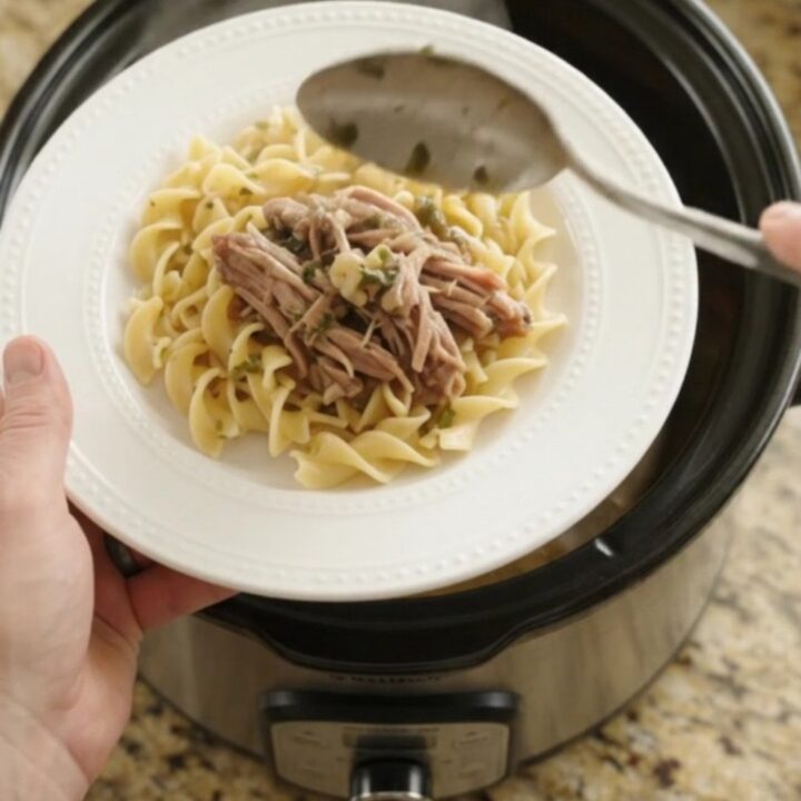 Slow cooker pork shoulder with potatoes and carrots in garlic butter sauce