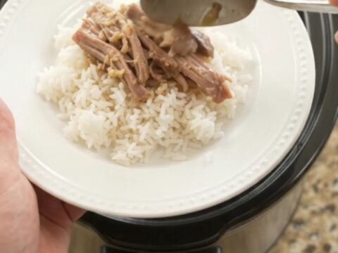 Slow-cooker pork shoulder with creamy Dijon sauce and portobello mushrooms in a black crockpot