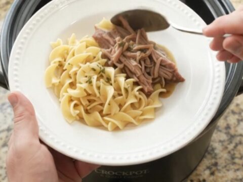 Slow-cooker pork shoulder with peppers and onions in a rich garlic-butter gravy
