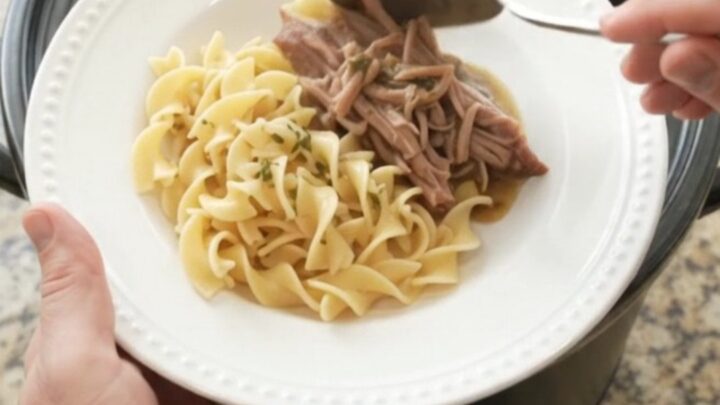 Slow-cooker pork shoulder with peppers and onions in a rich garlic-butter gravy