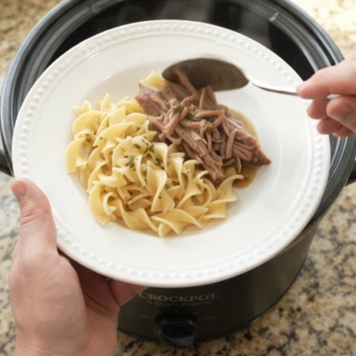 Slow-cooker pork shoulder with peppers and onions in a rich garlic-butter gravy