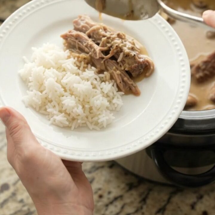 Shredded pork sirloin roast in creamy mushroom Dijon gravy in a slow cooker
