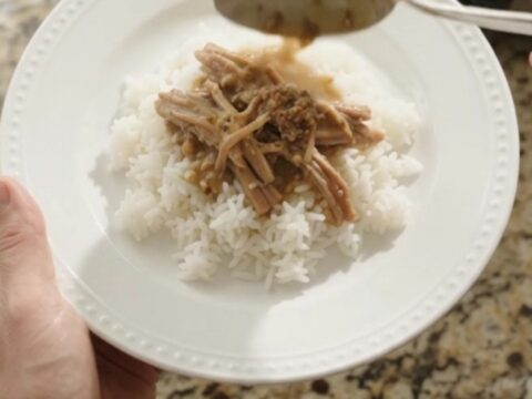 Slow cooker pork sirloin roast with potatoes and carrots in creamy Dijon gravy