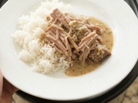 Shredded pork sirloin roast with portobello mushrooms in creamy Dijon sauce in a slow cooker