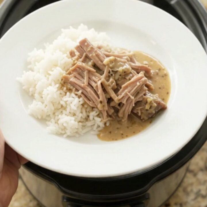 Shredded pork sirloin roast with portobello mushrooms in creamy Dijon sauce in a slow cooker