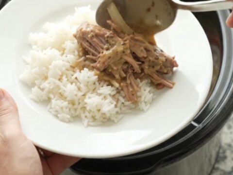 Shredded pork sirloin roast with bell peppers and onions in a creamy Dijon sauce, served in a slow cooker