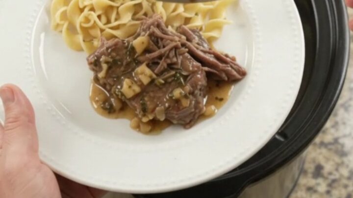 Fork-tender pepperoncini ranch garlic butter pot roast in a slow cooker with rich gravy
