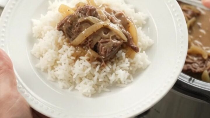 Slow-cooker French onion Dijon cream roast with tender beef and creamy gravy in a black crock