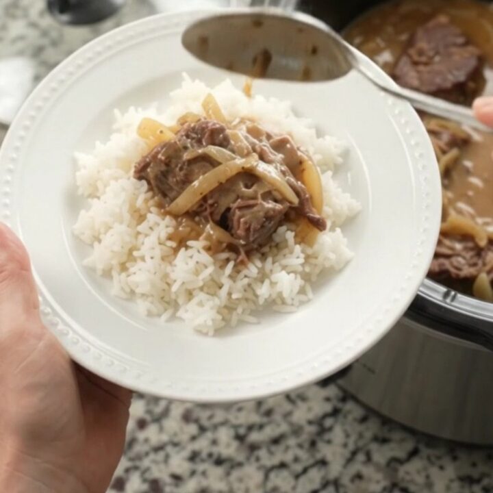 Slow-cooker French onion Dijon cream roast with tender beef and creamy gravy in a black crock
