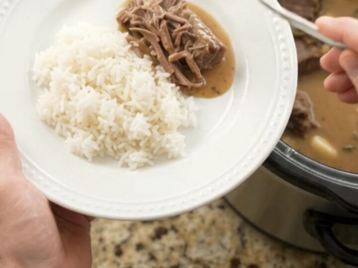 Fork-tender beef roast in creamy Dijon sauce with garlic and herbs in a slow cooker