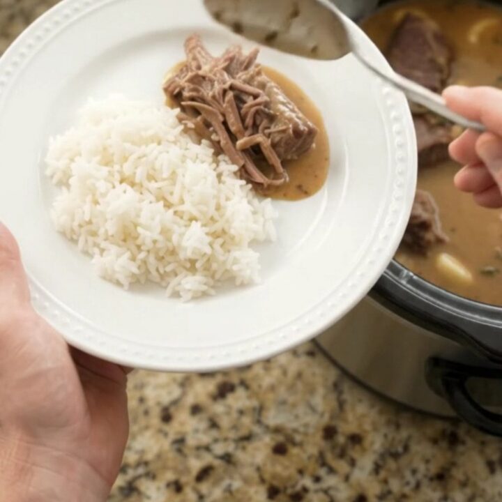 Fork-tender beef roast in creamy Dijon sauce with garlic and herbs in a slow cooker