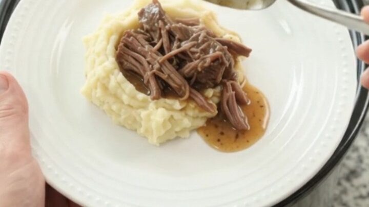 Slow cooker beef roast with potatoes and carrots in golden butter jus