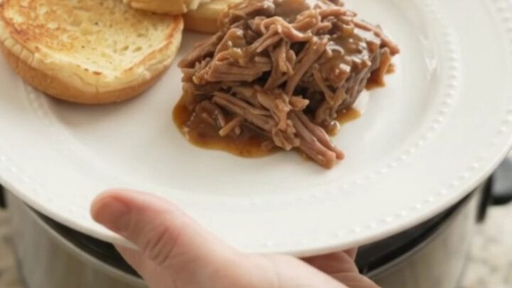 Slow-cooker beef pot roast with potatoes and carrots in rich brown gravy