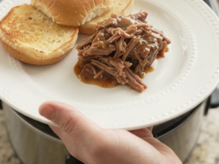Slow-cooker beef pot roast with potatoes and carrots in rich brown gravy