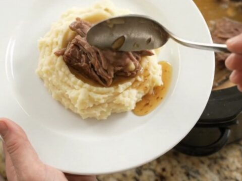 Fork-tender beef roast with portobello mushrooms in a buttery jus in a slow cooker