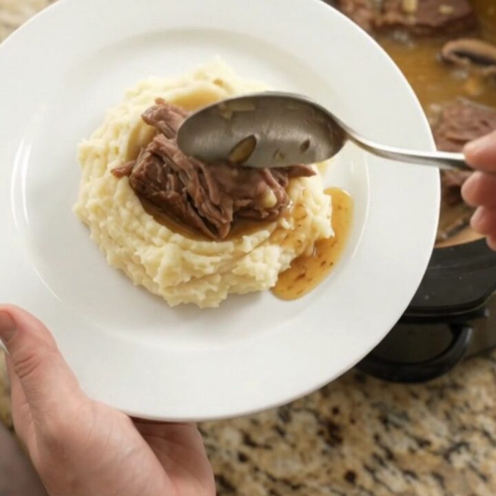 Fork-tender beef roast with portobello mushrooms in a buttery jus in a slow cooker