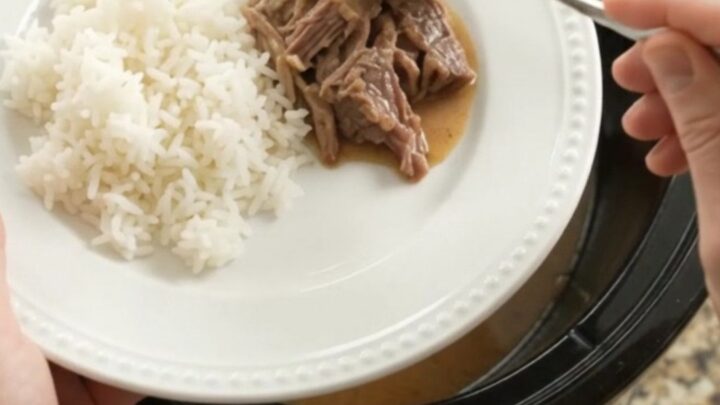 Shredded beef pot roast with potatoes and carrots in creamy Dijon gravy in a slow cooker